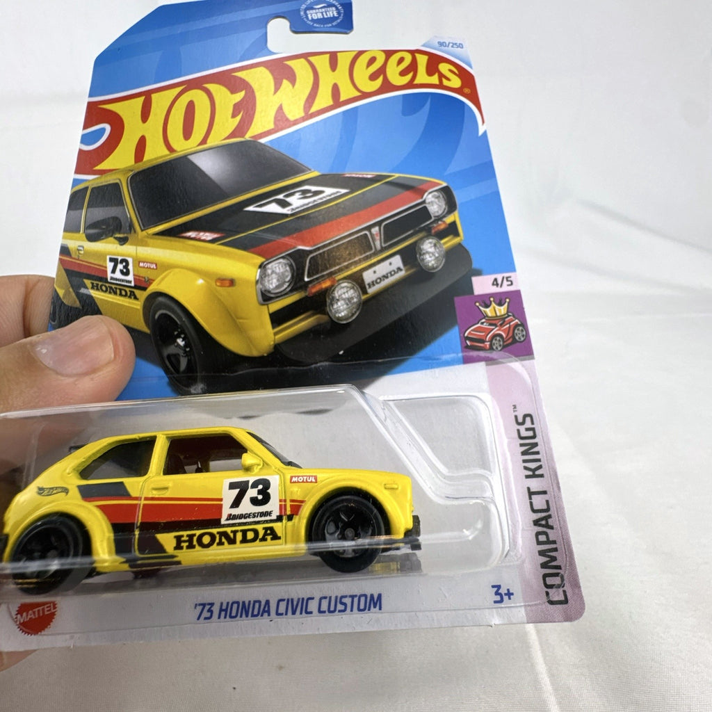 Hot Wheels 1:64 scale 1973 Honda Civic Custom diecast car in yellow, factory sealed on original card