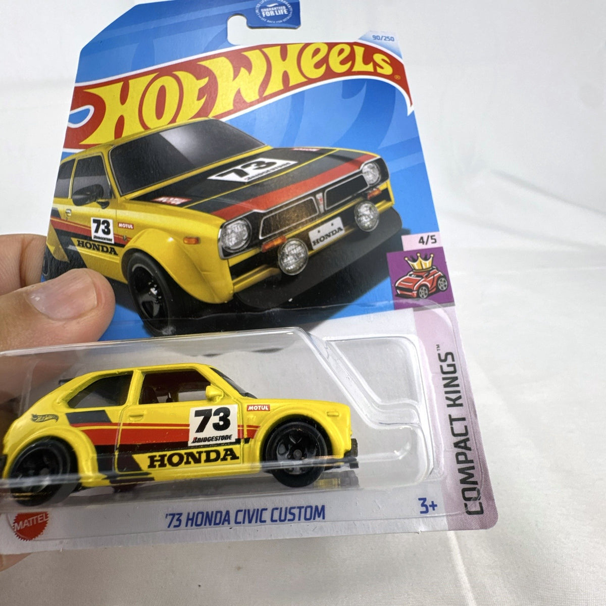 Hot Wheels 1:64 scale 1973 Honda Civic Custom diecast car in yellow, factory sealed on original card