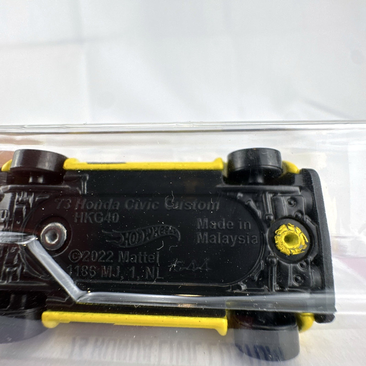 Hot Wheels 1:64 scale 1973 Honda Civic Custom diecast car in yellow, factory sealed on original card