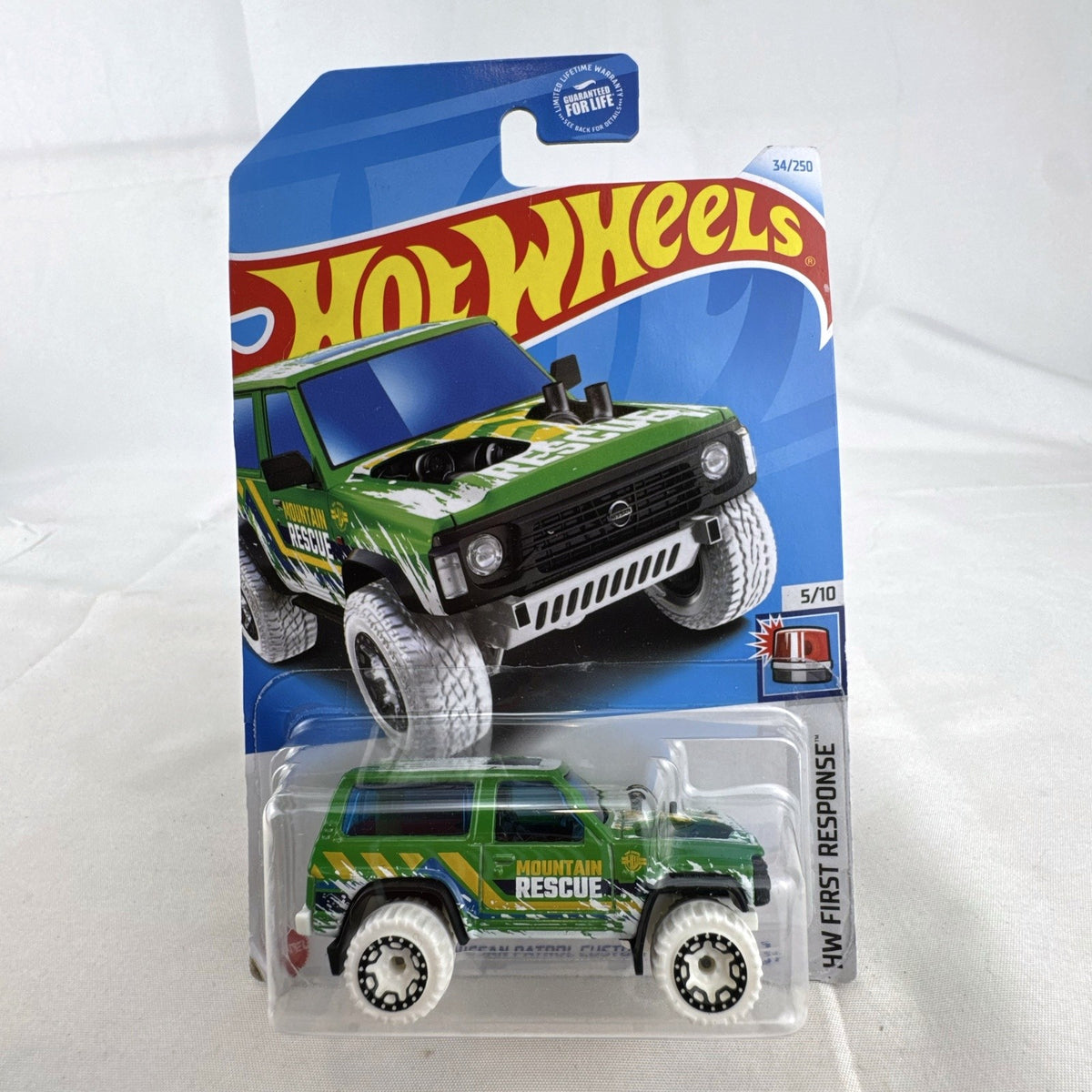Hot Wheels Nissan Patrol Custom 1:64 diecast truck in green Mountain Rescue livery sealed on card.
