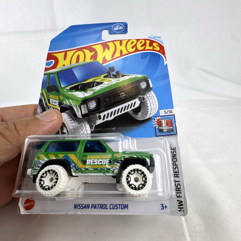 Hot Wheels Nissan Patrol Custom 1:64 diecast truck in green Mountain Rescue livery sealed on card.