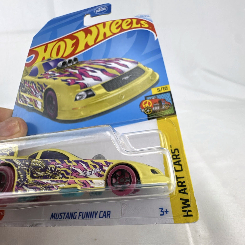 Sealed Hot Wheels 1:64 scale Ford Mustang Funny Car in yellow with HW Art Cars graphics on original packaging.