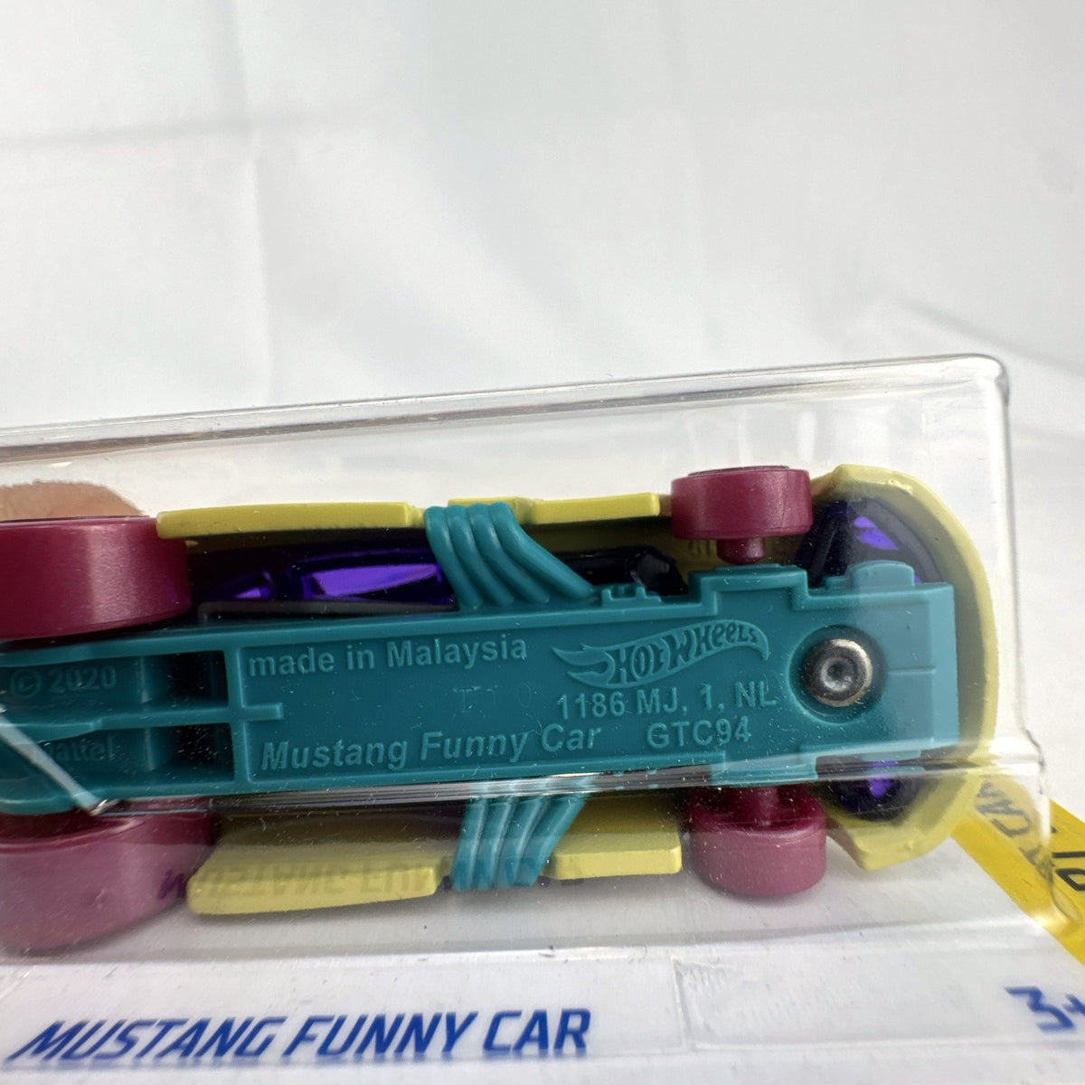 Sealed Hot Wheels 1:64 scale Ford Mustang Funny Car in yellow with HW Art Cars graphics on original packaging.