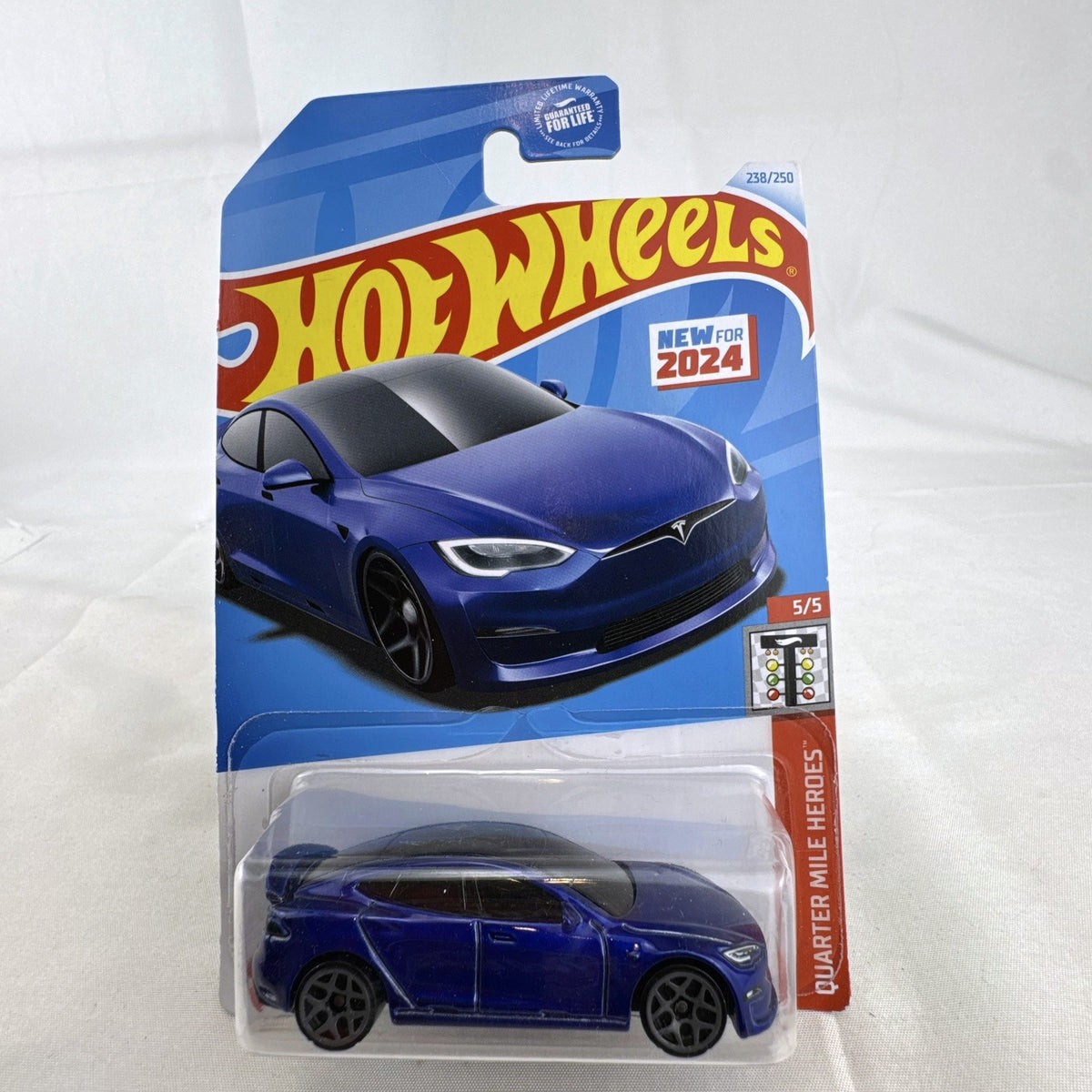 Factory sealed Hot Wheels 1:64 scale Tesla Model S Plaid diecast car in metallic blue on original 2024 card.
