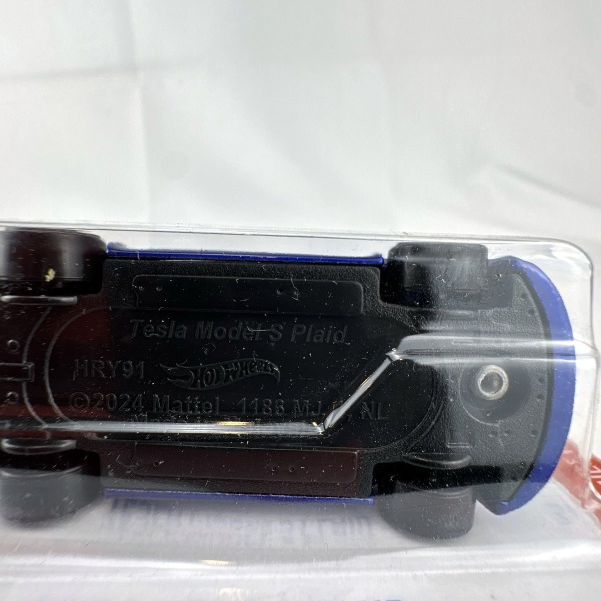 Factory sealed Hot Wheels 1:64 scale Tesla Model S Plaid diecast car in metallic blue on original 2024 card.
