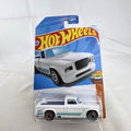 Hot Wheels 1:64 scale 1963 Studebaker Champ pickup truck in white with teal side graphics, sealed in original package.