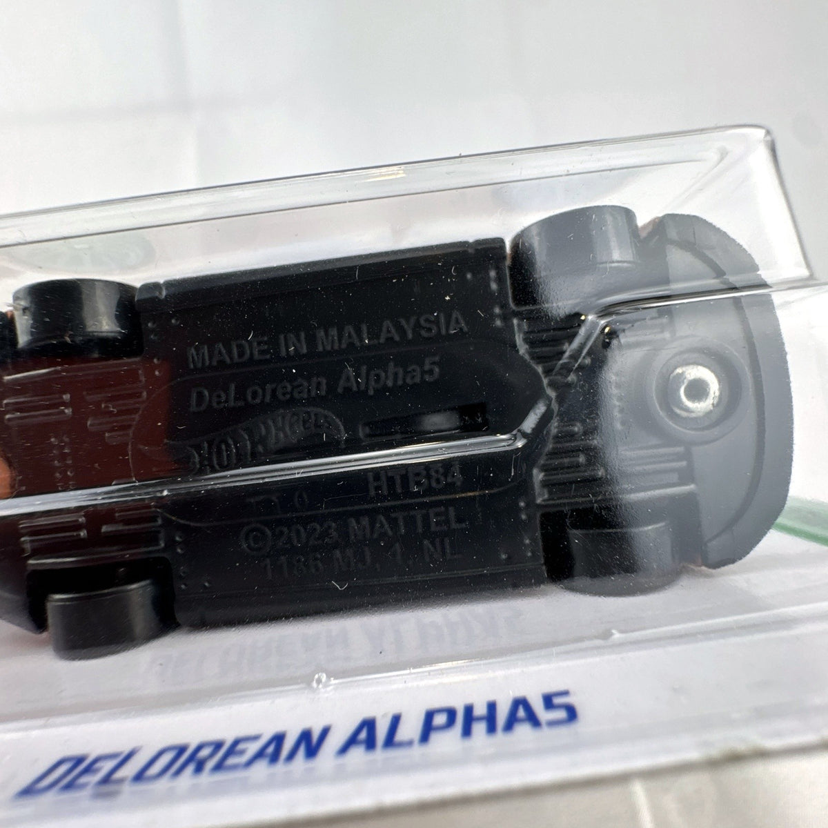 Hot Wheels 1:64 scale DeLorean Alpha5 diecast car in metallic copper sealed on original HW Green Speed card.