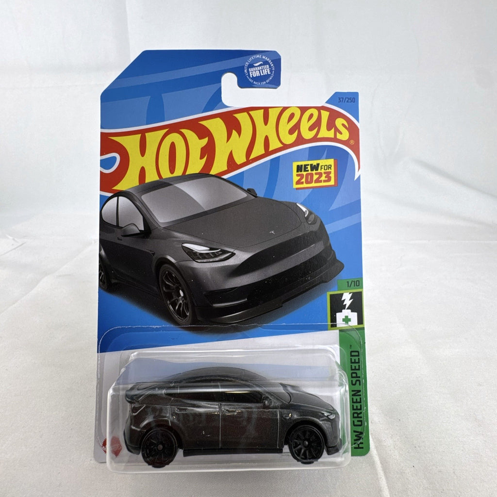 Hot Wheels 1:64 scale diecast Tesla Model Y SUV in dark gray metallic inside factory sealed card packaging.