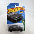 Hot Wheels 1:64 scale diecast Tesla Model Y SUV in dark gray metallic inside factory sealed card packaging.