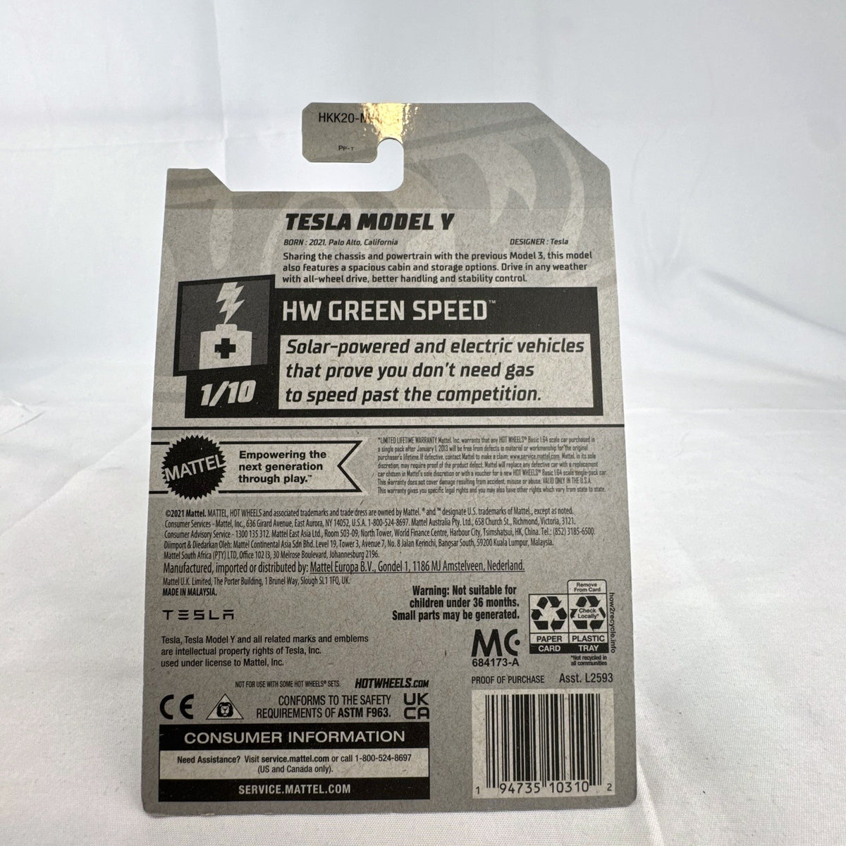 Hot Wheels 1:64 scale diecast Tesla Model Y SUV in dark gray metallic inside factory sealed card packaging.