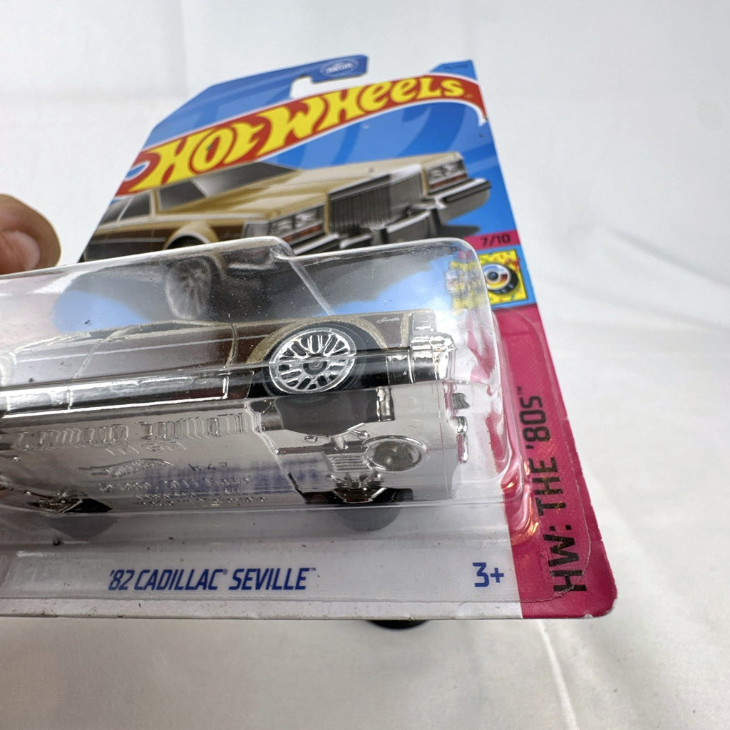 Hot Wheels 1:64 scale 1982 Cadillac Seville diecast car in gold two-tone finish, factory sealed on original card.