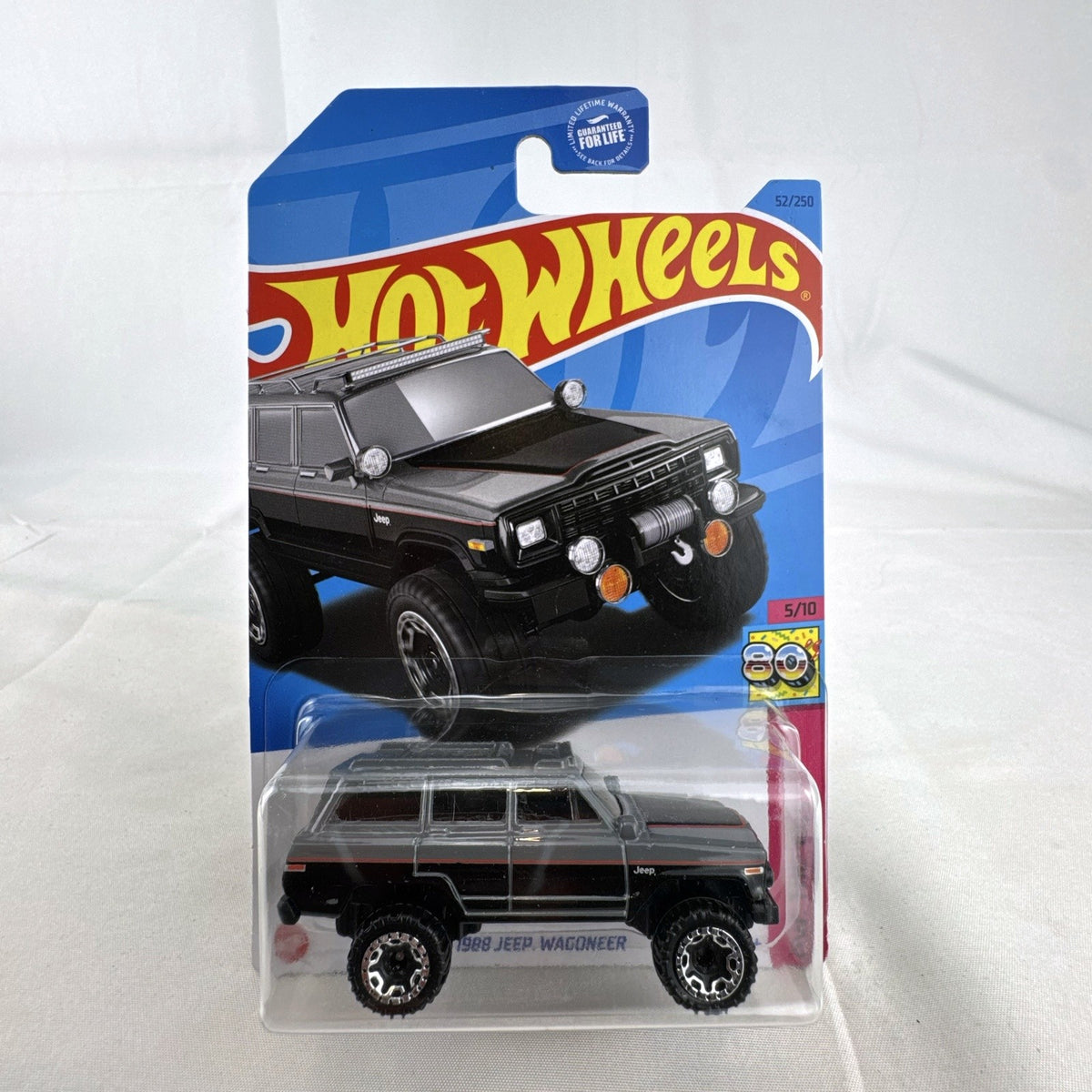 Unopened Hot Wheels 1988 Jeep Wagoneer 1:64 scale dark gray diecast SUV in original HW The 80s series blister card.