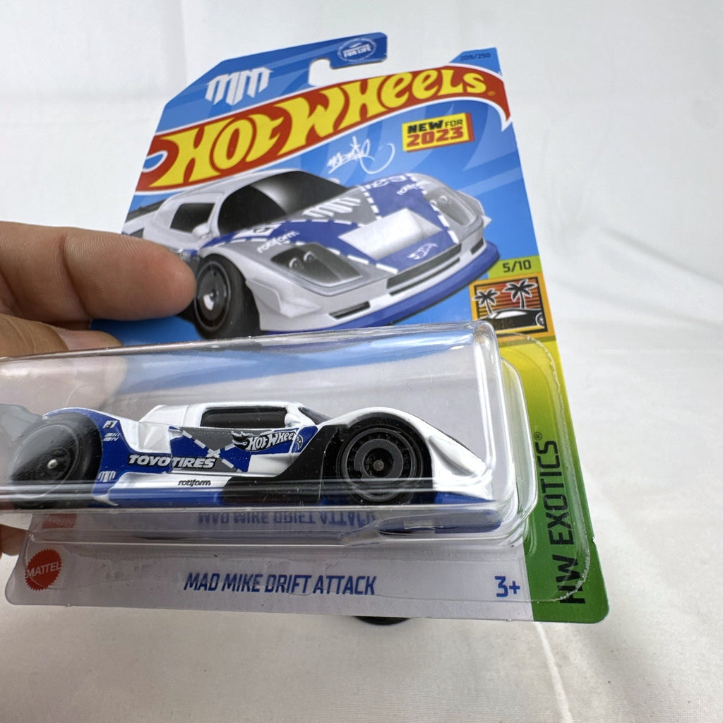 Hot Wheels 1:64 scale Mad Mike Drift Attack diecast car in white with race graphics, factory sealed on original card
