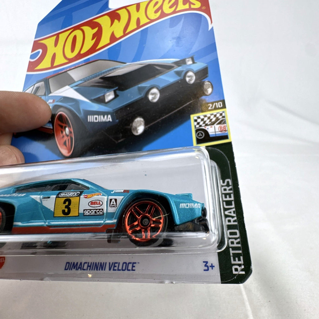 Hot Wheels Dimachinni Veloce 1:64 scale diecast rally car in metallic blue unopened on cardback