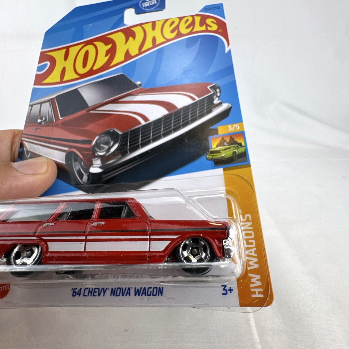 Hot Wheels 1964 Chevy Nova Wagon 1:64 scale diecast car in deep red with white roof sealed on blister card.