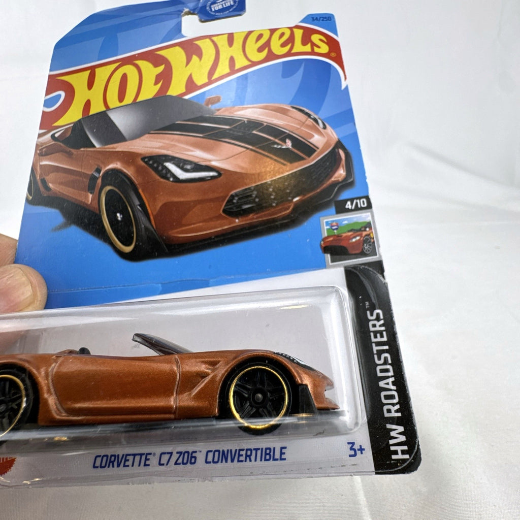 Hot Wheels 1:64 scale Chevrolet Corvette C7 Z06 Convertible diecast car in metallic copper brown sealed on card