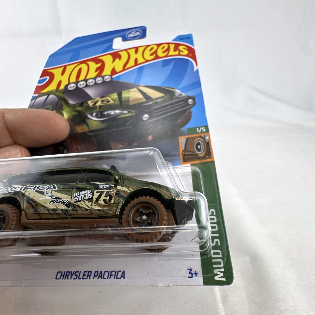 Sealed Hot Wheels 1:64 Chrysler Pacifica Mud Studs diecast van in green camouflage packaging.