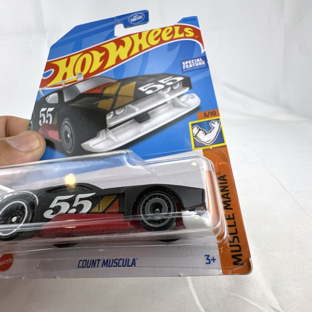 Hot Wheels Count Muscula 1:64 scale diecast muscle car in matte black with sealed blister pack packaging.