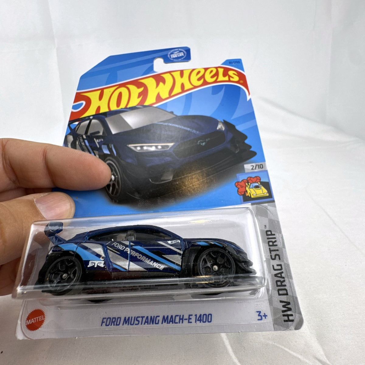 Hot Wheels 1:64 scale dark blue Ford Mustang Mach-E 1400 diecast car in original blister card packaging.