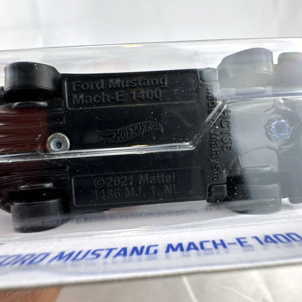 Hot Wheels 1:64 scale dark blue Ford Mustang Mach-E 1400 diecast car in original blister card packaging.
