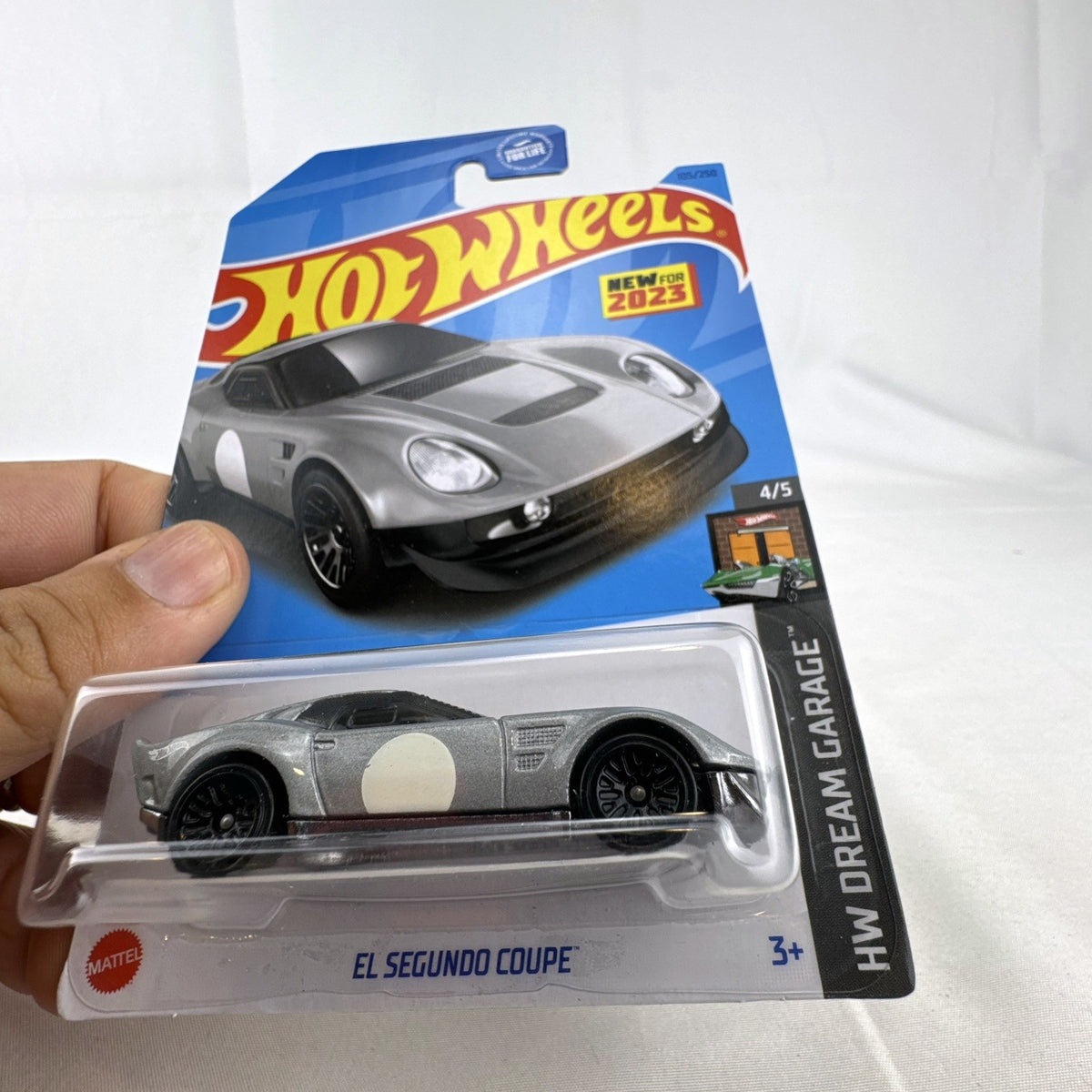 Hot Wheels 1:64 scale El Segundo Coupe diecast car in silver, sealed on original HW Dream Garage card.