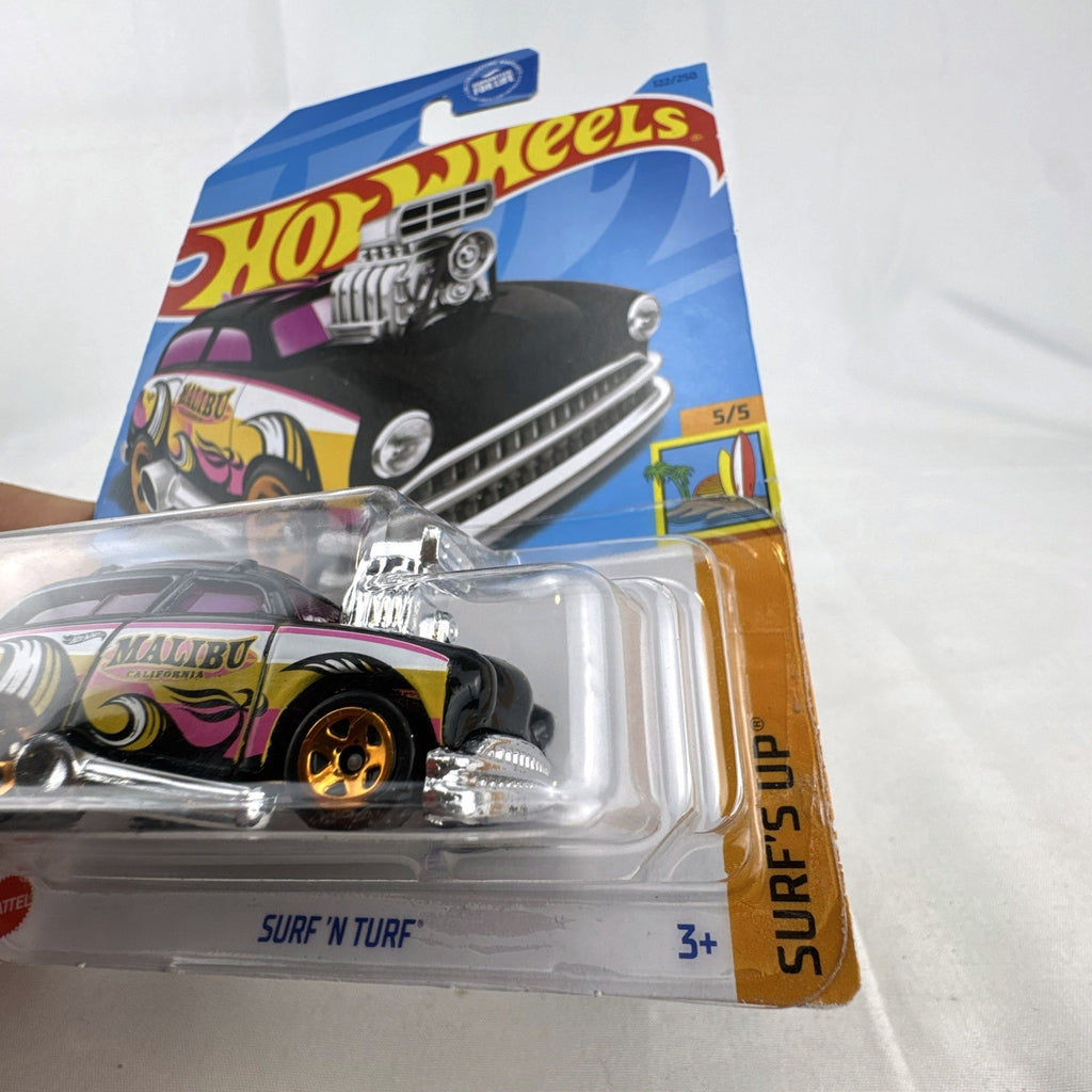 Hot Wheels Surf 'N Turf 1:64 scale diecast hot rod wagon in black with Malibu California tampo graphics in unopened pack