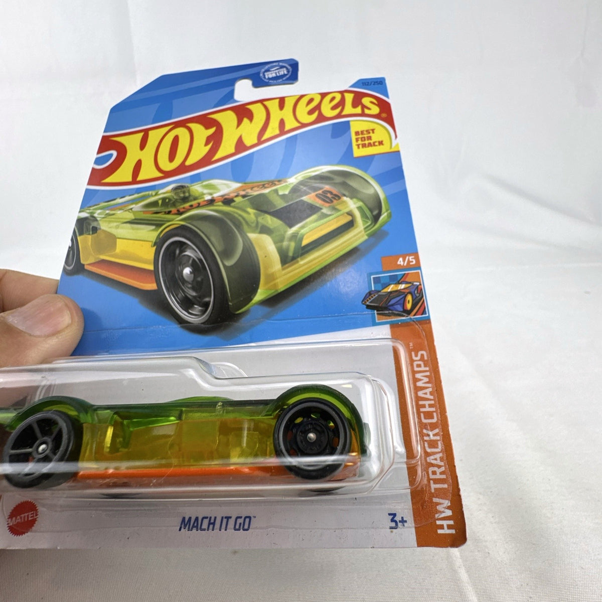 Hot Wheels Mach It Go 1:64 scale diecast car in translucent green sealed on original HW Track Champs blister card.