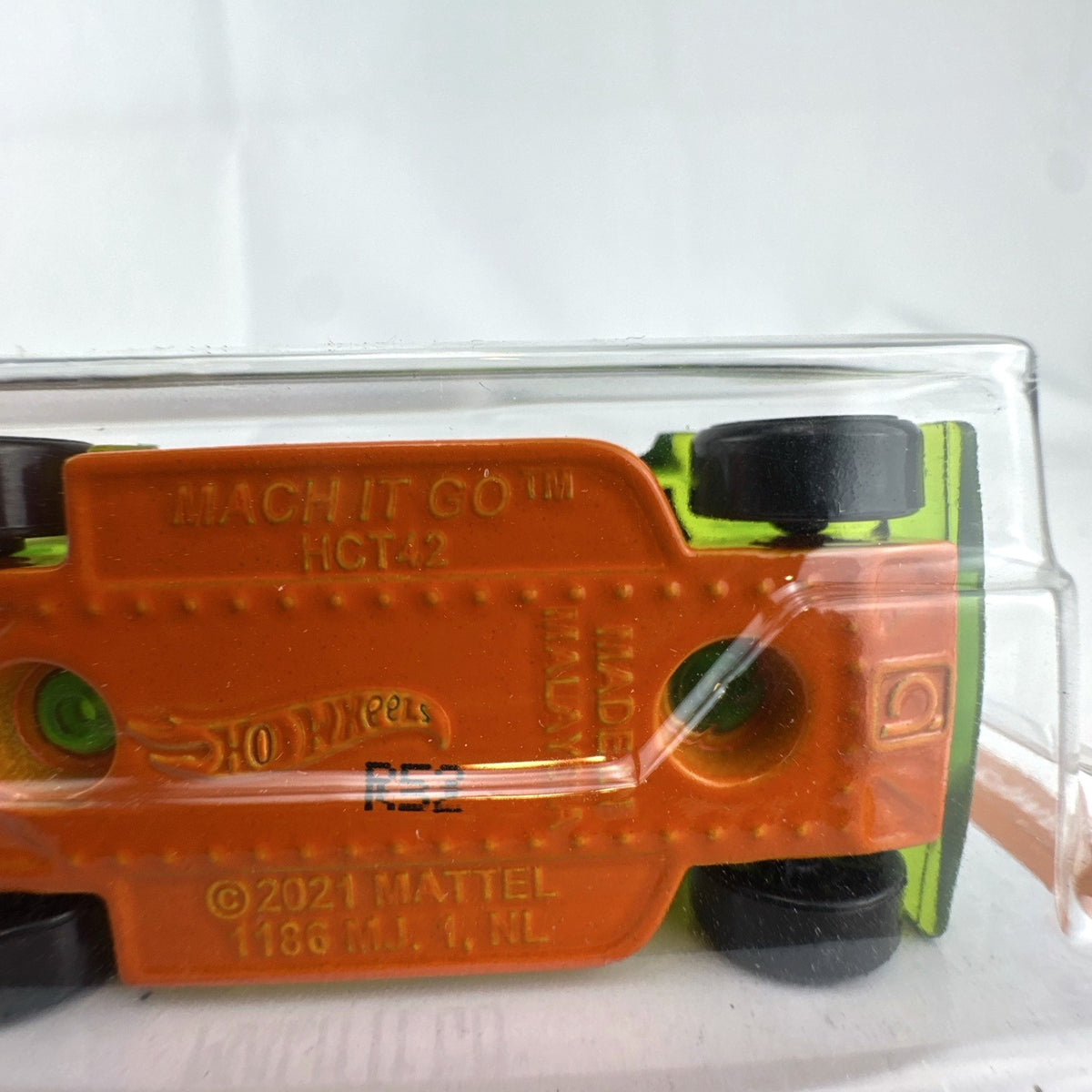 Hot Wheels Mach It Go 1:64 scale diecast car in translucent green sealed on original HW Track Champs blister card.