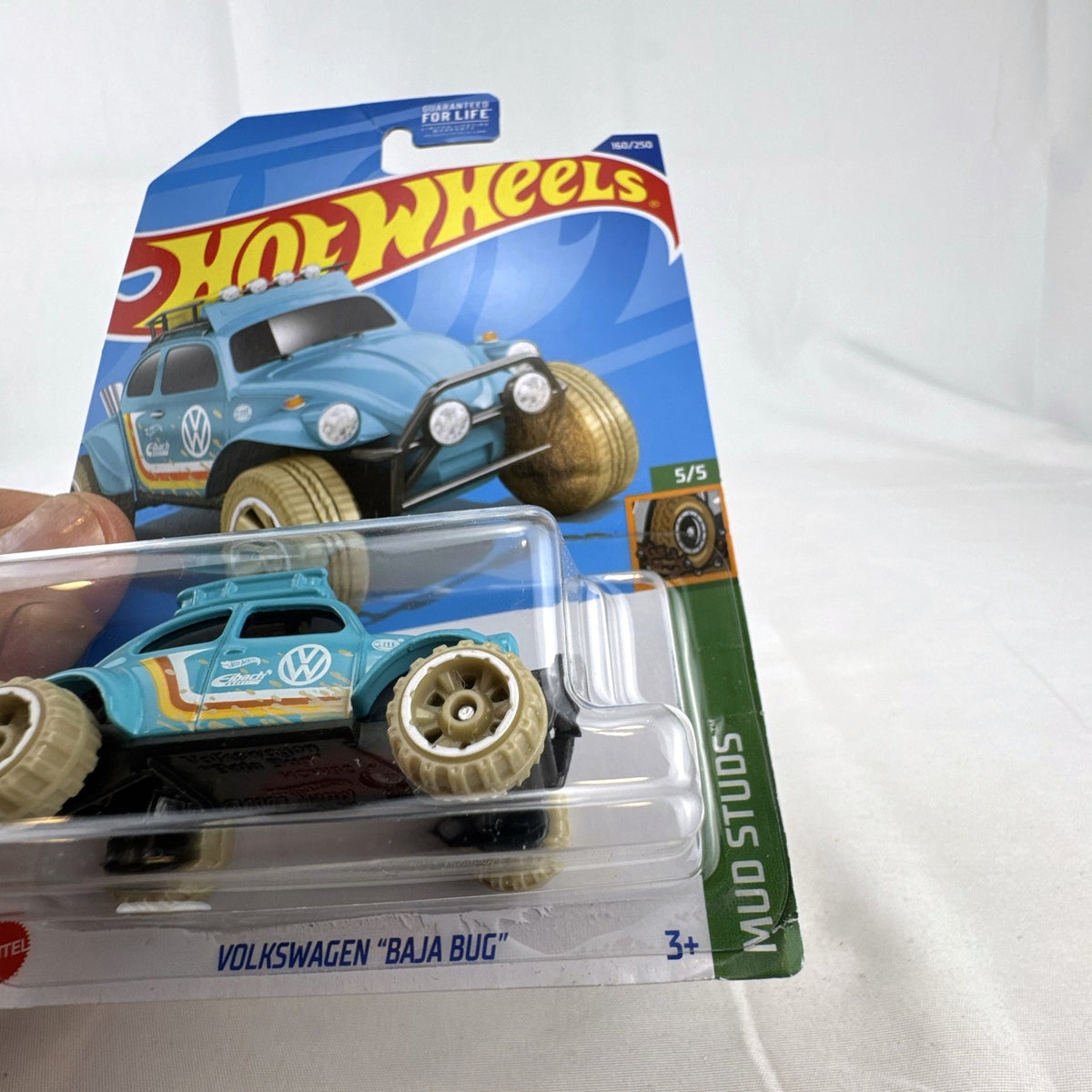 Hot Wheels 1:64 scale Volkswagen Baja Bug diecast car in light blue from the Mud Studs series sealed on card