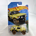 Hot Wheels 1:64 scale Land Rover Range Rover Classic Mud Studs diecast SUV in yellow blister package