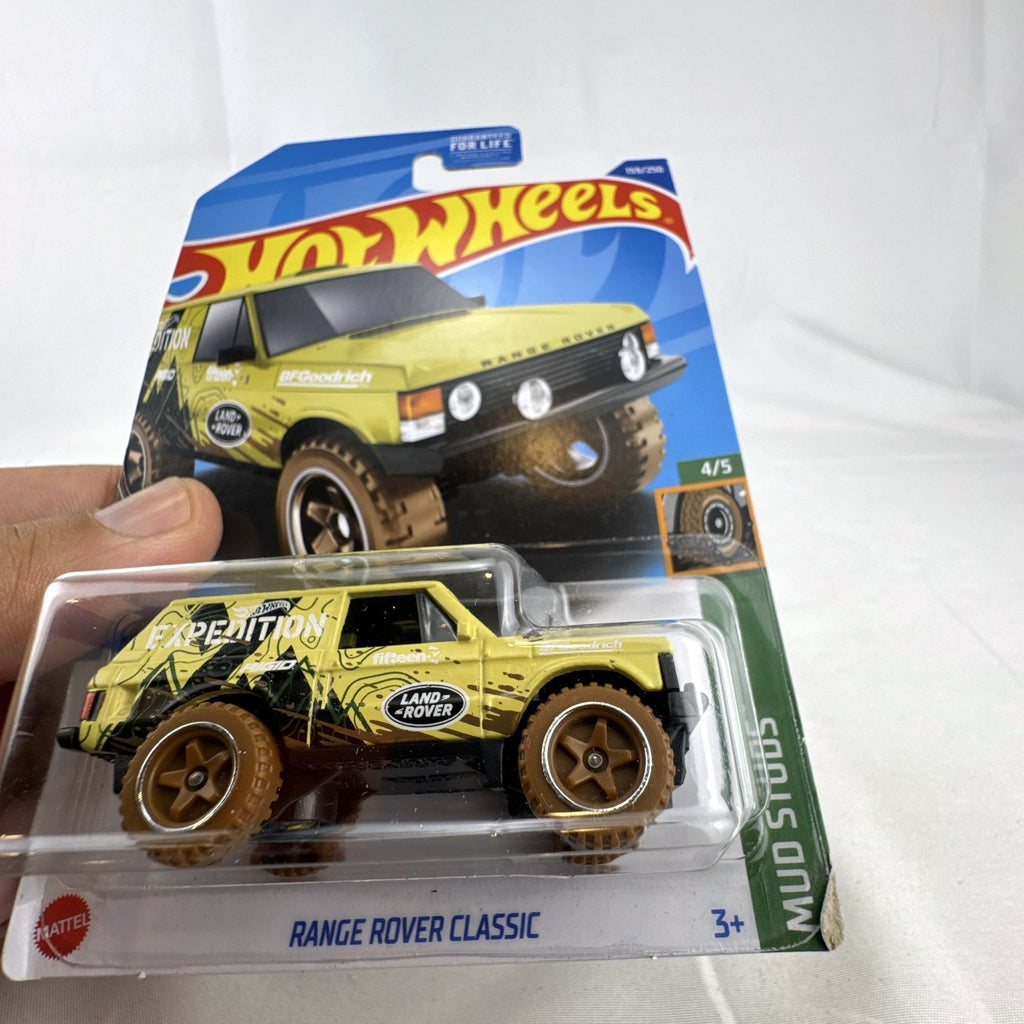 Hot Wheels 1:64 scale Land Rover Range Rover Classic Mud Studs diecast SUV in yellow blister package