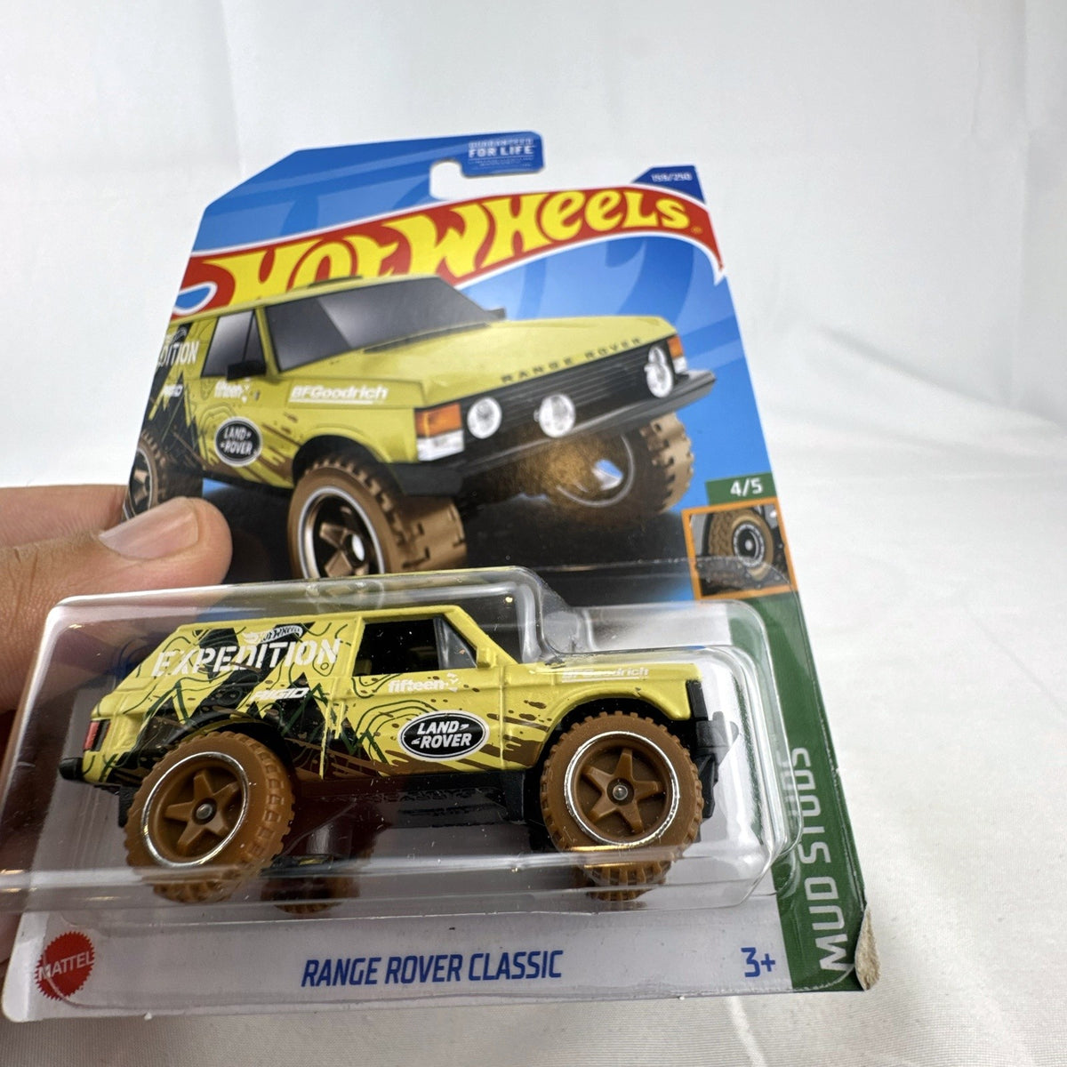 Hot Wheels 1:64 scale Land Rover Range Rover Classic Mud Studs diecast SUV in yellow blister package