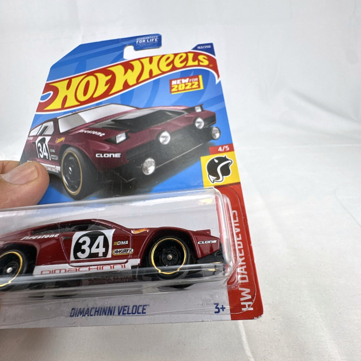 Hot Wheels 1:64 scale Dimachinni Veloce red diecast rally car sealed on 2022 HW Daredevils blister card.