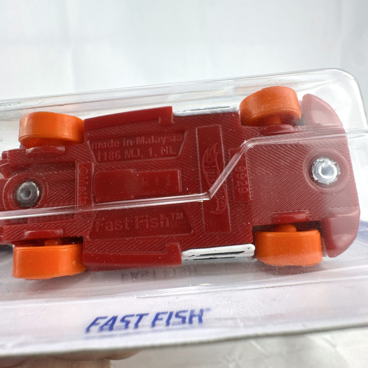 Hot Wheels 1:64 Fast Fish diecast car in white with orange wheels on original sealed blister card