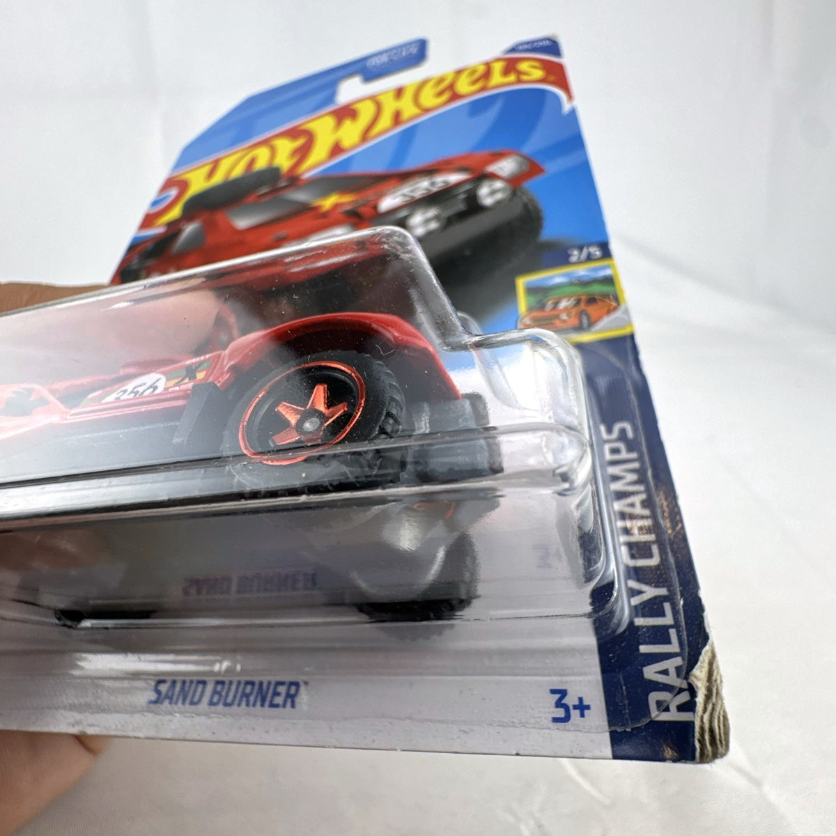 Hot Wheels 2022 Sand Burner 1:64 scale red diecast rally car in original blister card packaging.