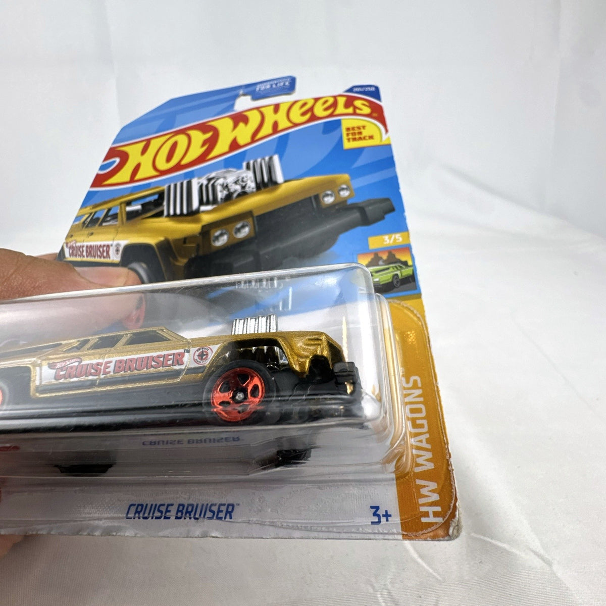 Hot Wheels Cruise Bruiser 1:64 scale diecast station wagon in metallic gold on original card.