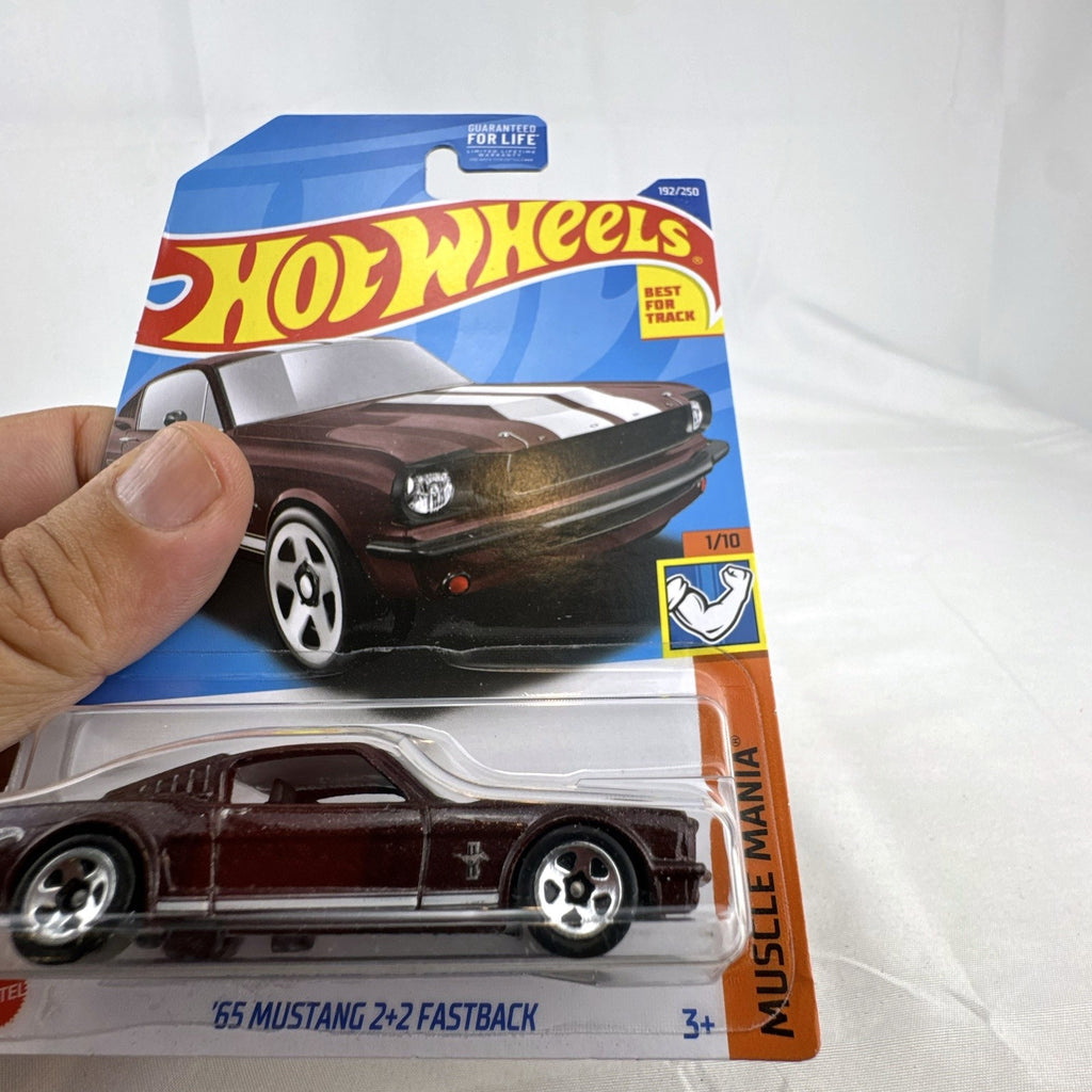 Hot Wheels 1:64 scale 1965 Ford Mustang 2+2 Fastback diecast car in dark maroon with white racing stripes factory sealed.