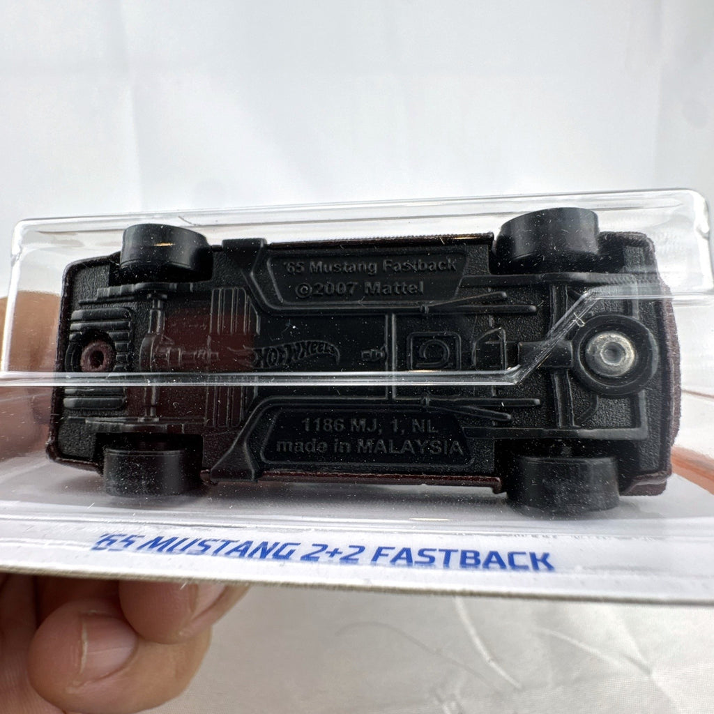 Hot Wheels 1:64 scale 1965 Ford Mustang 2+2 Fastback diecast car in dark maroon with white racing stripes factory sealed.