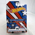 Hot Wheels 1965 Ford Ranchero 1:64 diecast in white with Stars & Stripes patriotic graphics, unopened on card.