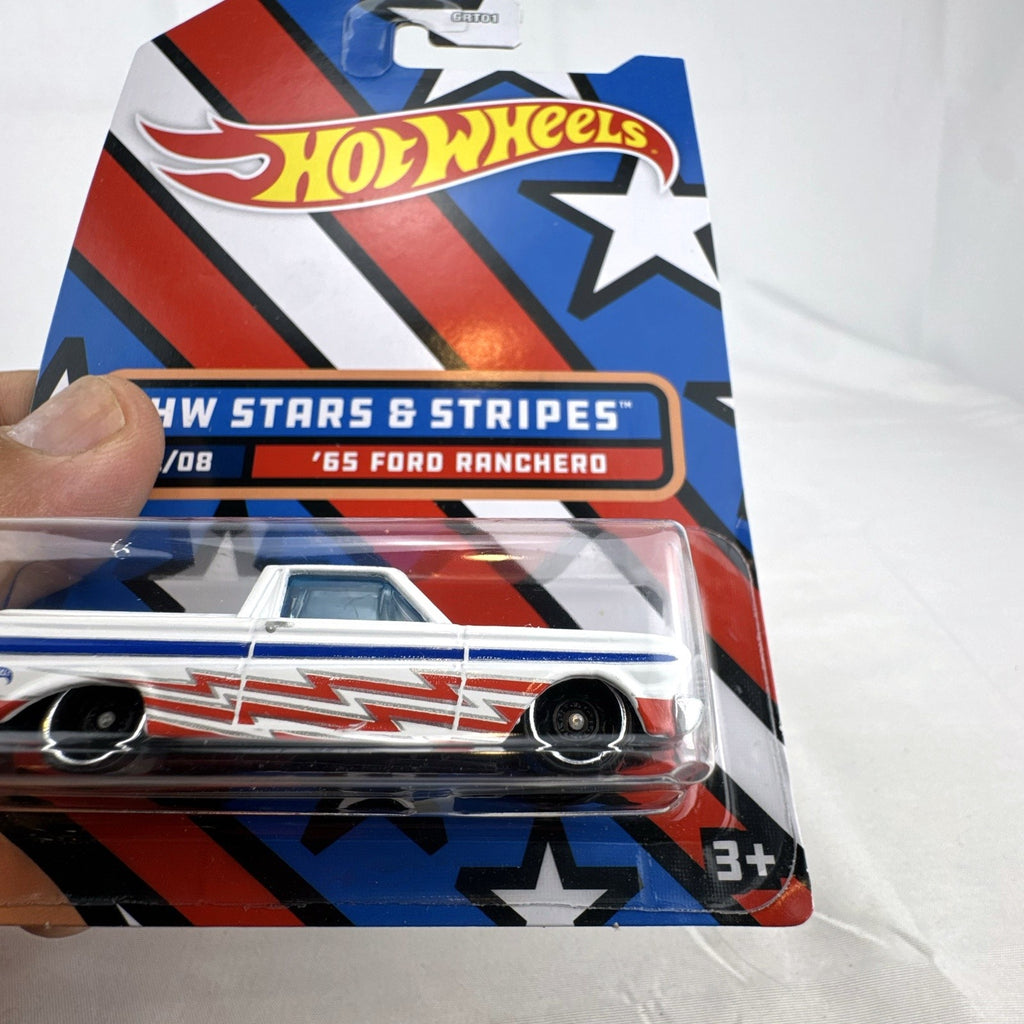 Hot Wheels 1965 Ford Ranchero 1:64 diecast in white with Stars & Stripes patriotic graphics, unopened on card.