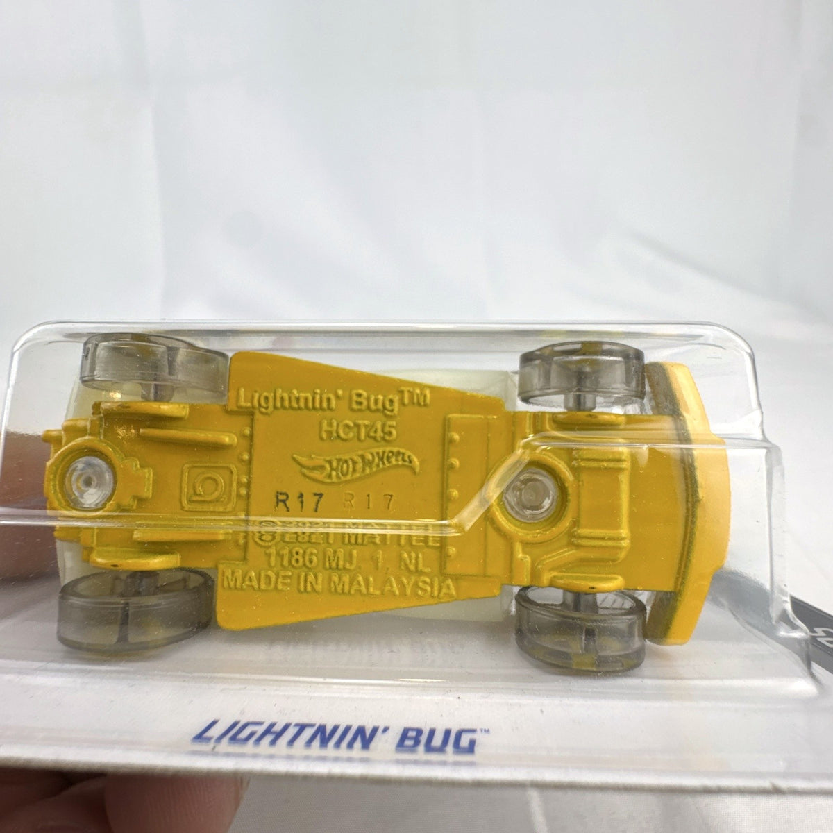 Sealed 2022 Hot Wheels Lightnin' Bug 1:64 scale diecast car in yellow X-Raycers translucent style on card