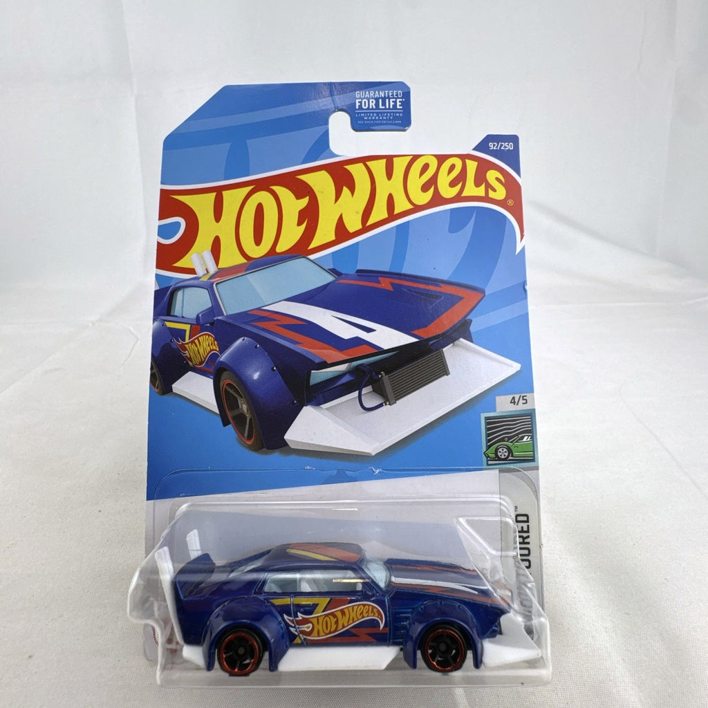 Hot Wheels Mad Manga 1:64 scale diecast car in dark blue, sealed on original HW Contoured blister card.