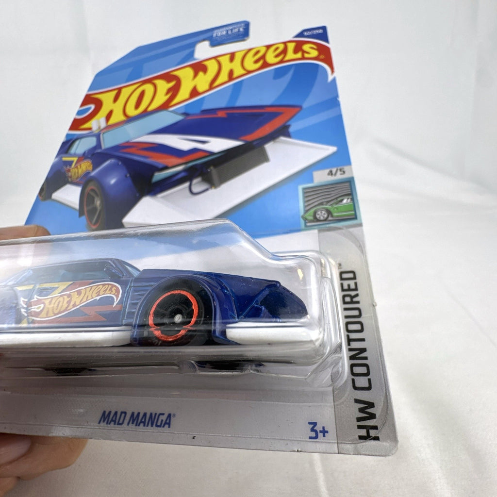 Hot Wheels Mad Manga 1:64 scale diecast car in dark blue, sealed on original HW Contoured blister card.