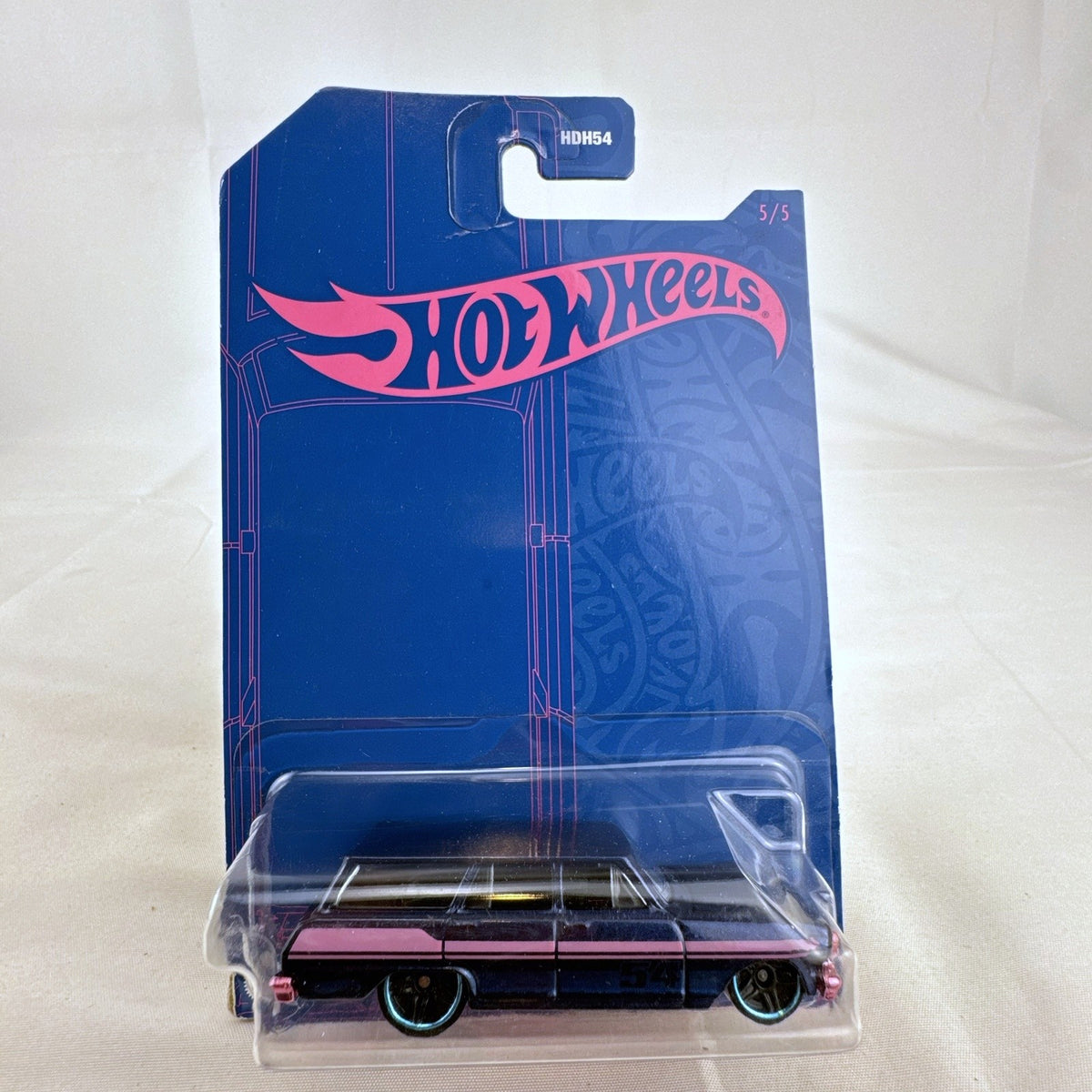 Hot Wheels 54th Anniversary 1:64 scale 1964 Chevy Nova Wagon diecast car in dark blue and pink original sealed packaging