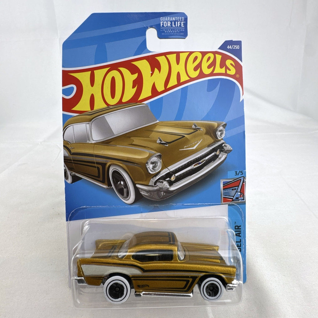 Hot Wheels 1957 Chevy Bel Air 1:64 scale diecast car in metallic gold with white wall tires sealed on card