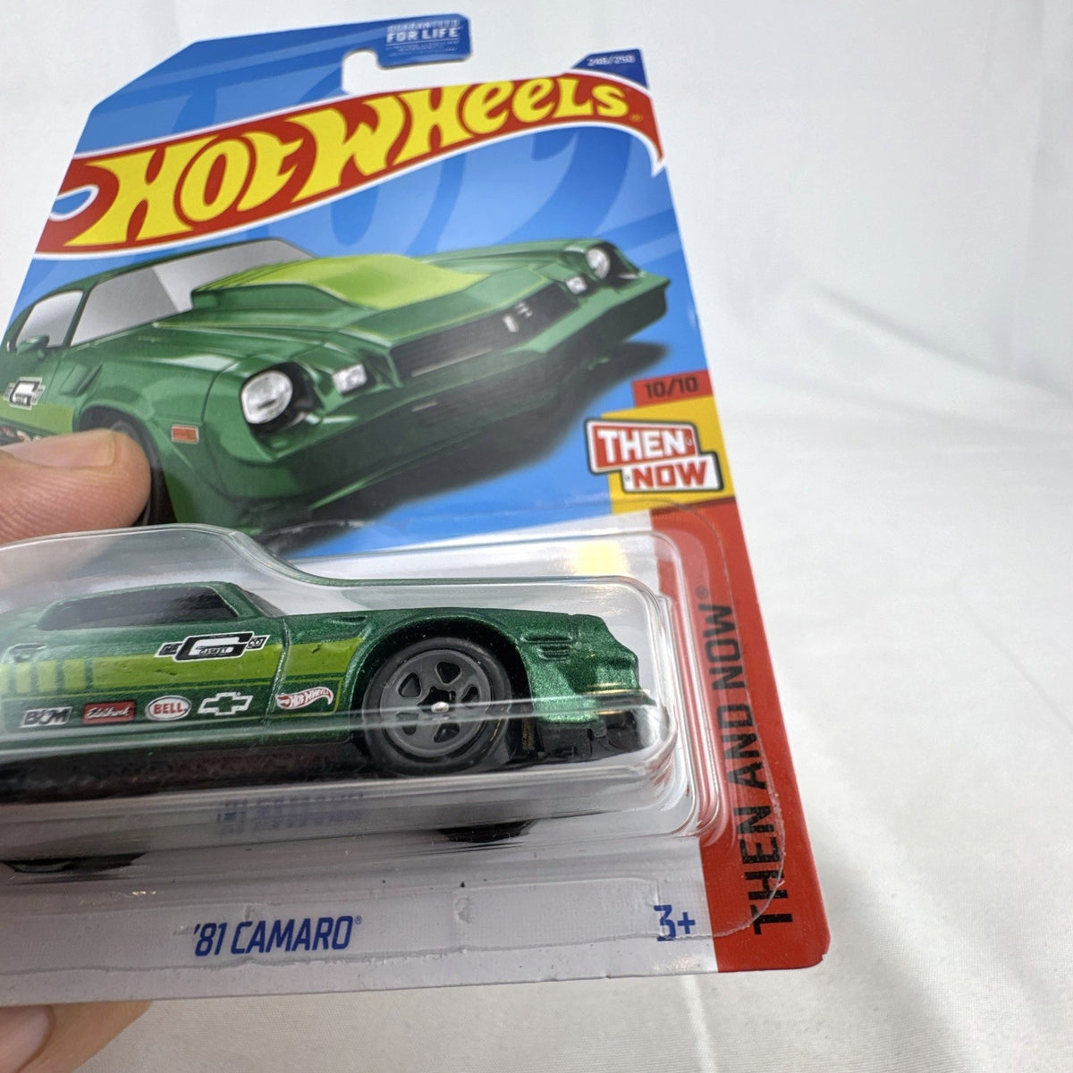 Hot Wheels 1:64 scale 1981 Chevrolet Camaro diecast car in metallic green, factory sealed on card.