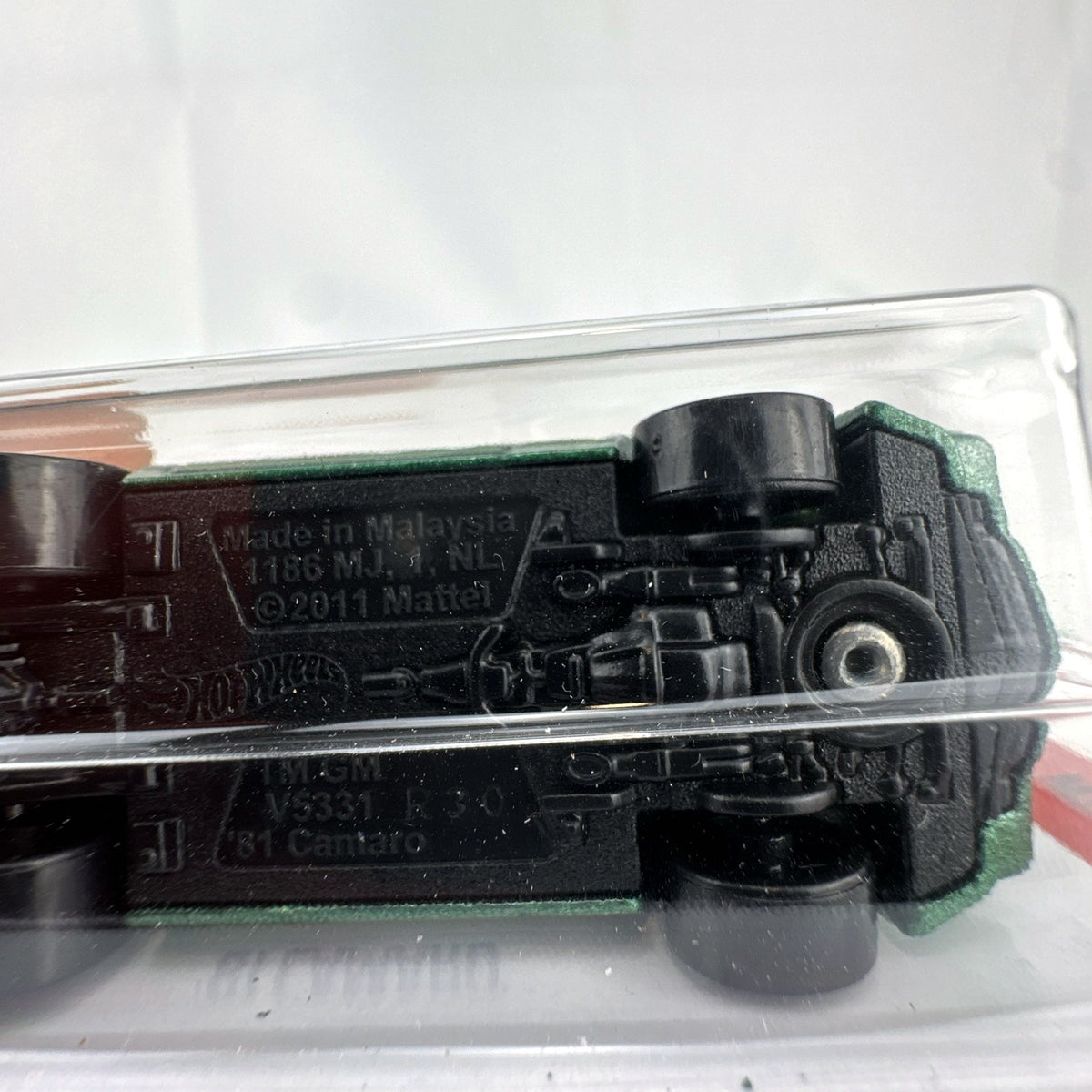 Hot Wheels 1:64 scale 1981 Chevrolet Camaro diecast car in metallic green, factory sealed on card.