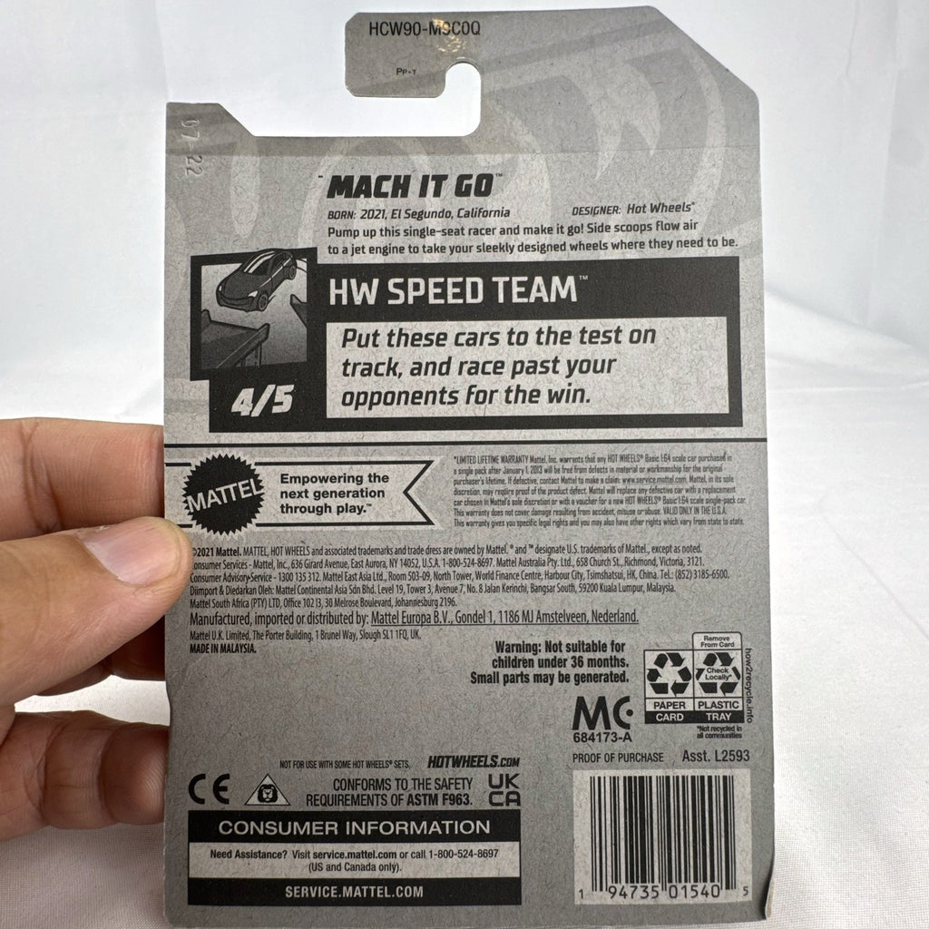 Hot Wheels Mach It Go 1:64 diecast car in factory sealed blister package with clear smoke body and orange track wheels.