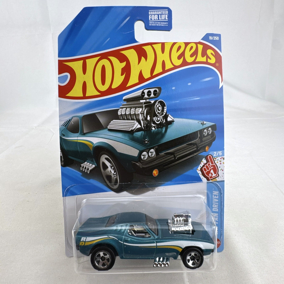 Hot Wheels Rodger Dodger 1:64 scale diecast muscle car in dark metallic teal, unopened on original card packaging.
