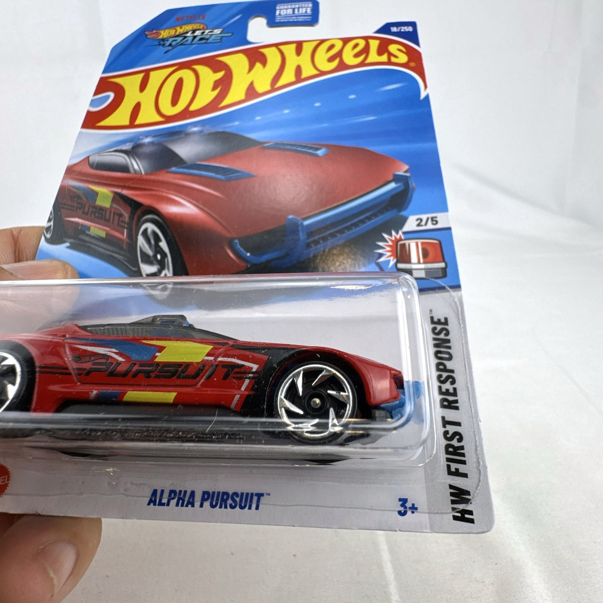 Red Hot Wheels 1:64 scale Alpha Pursuit diecast vehicle in factory-sealed HW First Response blister pack.